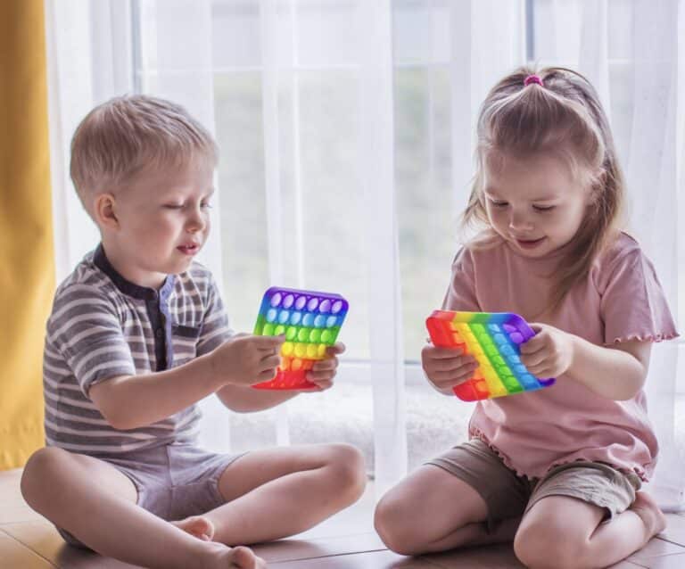 kids playing with toy to help with Common Sensory Issues in Autism